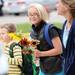 Fifth-grader Arianna Gipson Infante, 9, smiles as she carries sunflowers, a gift for her teacher at Logan Elementary School on the first day of school on Tuesday, September 3, 2013. Melanie Maxwell | AnnArbor.com